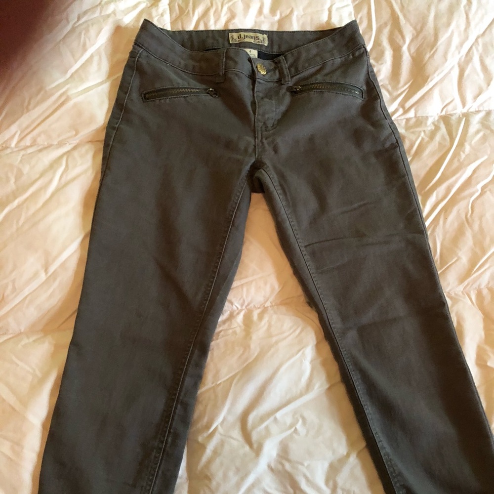 Soft, olive color jeans with brass colored trim.